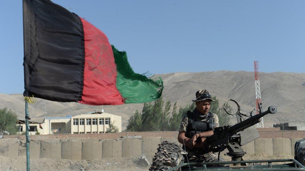 An Afghan security force member keeps watch at the site of a suicide attack in Maidan Shar, the capital city of Wardak province south of Kabul