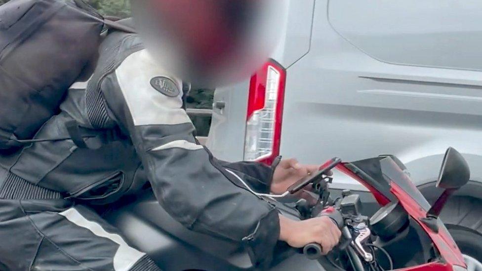 Motorcyclist using mobile phone