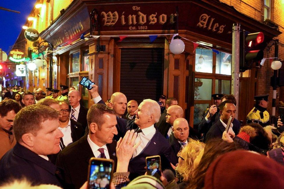 Joe Biden takes a selfie outside a pub in County Louth as hundreds of people surround him