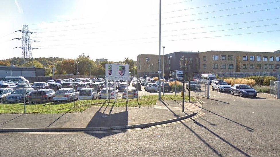 Chiltern Academy, with sign in front, car park and office block building behind