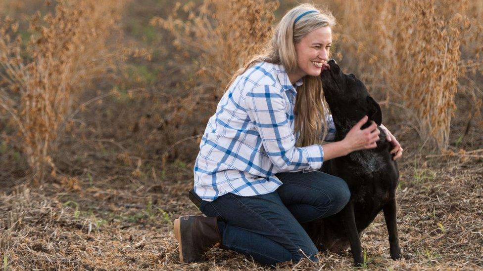 Rachael Sharp, a third-generation farmer in the US state of South Carolina. With Laney the dog.