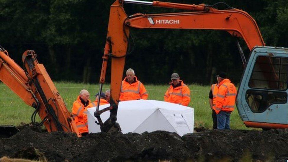 Members of the Independent Commission for the Location of Victims' Remains work at the scene