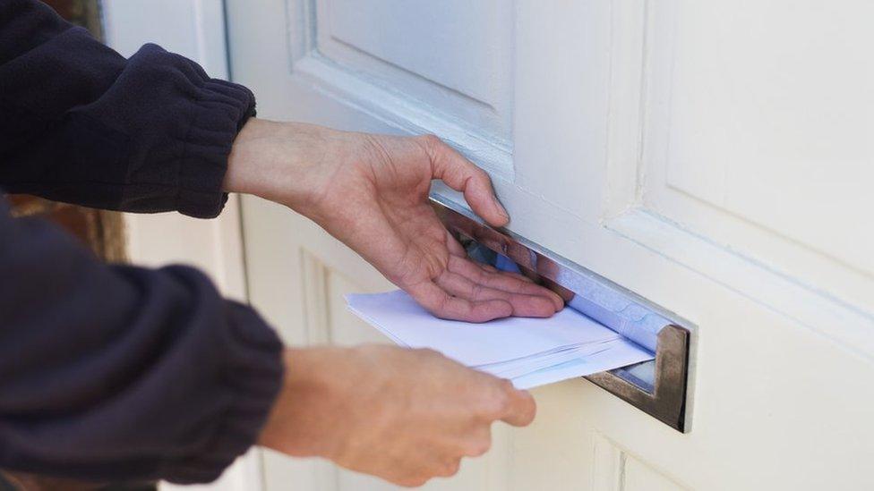 Postal worker delivering mail