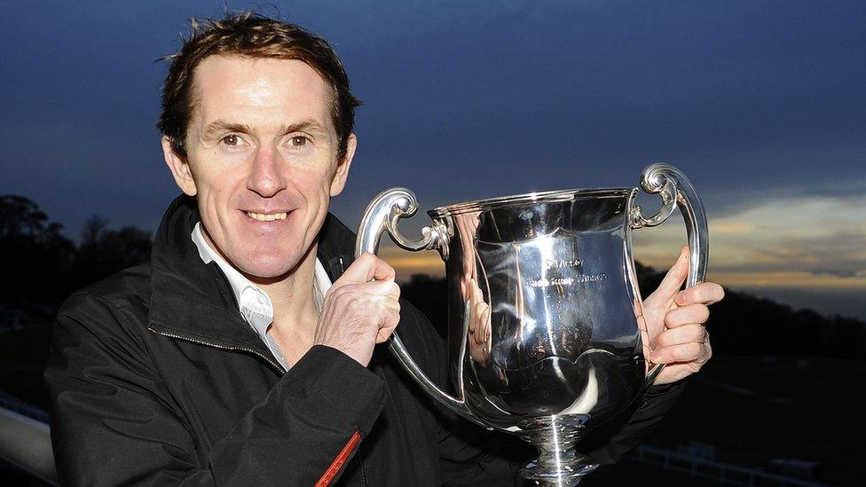 In 2013, McCoy posed with his trophy marking his 4000th career victory