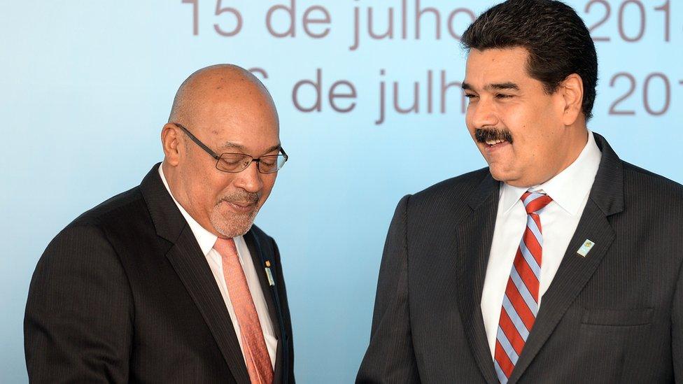 Suriname's President Desire Bouterse (L) and Venezuela's President Nicolas Maduro shake hands before the family photo of the BRICS-UNASUR Summit in Brasilia on July 16, 2014.