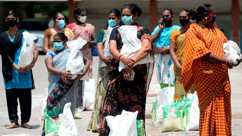 Transgender people stand maintaining social distancing as they receive free food distribution during a government-imposed nationwide lockdown