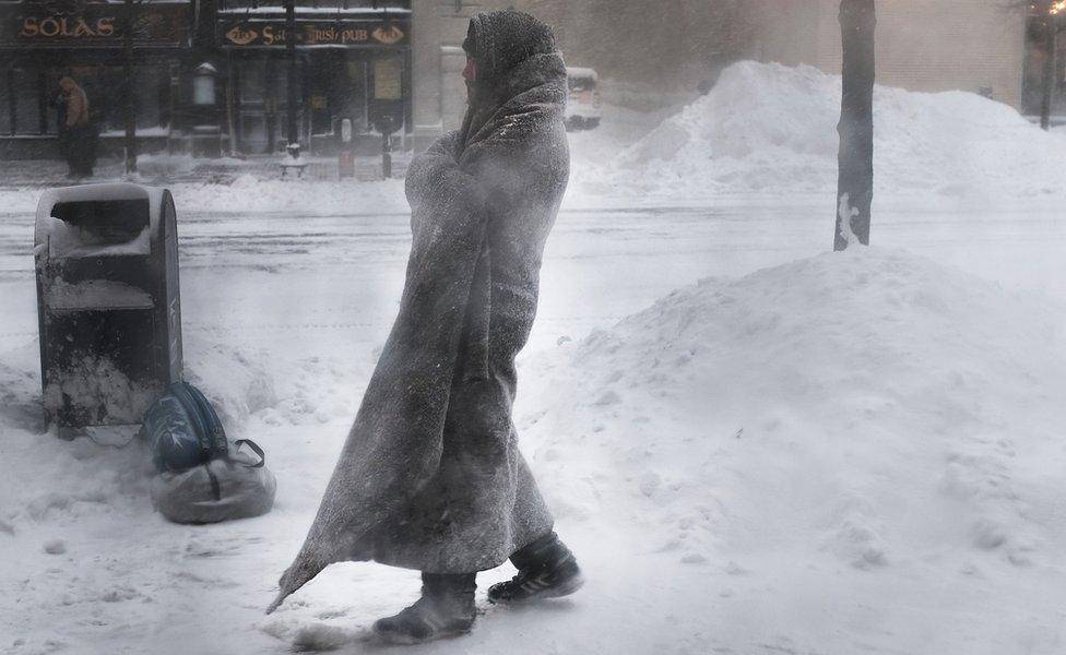 A homeless man on the streets of Boston as snow falls from a massive winter storm, 4 January 2018