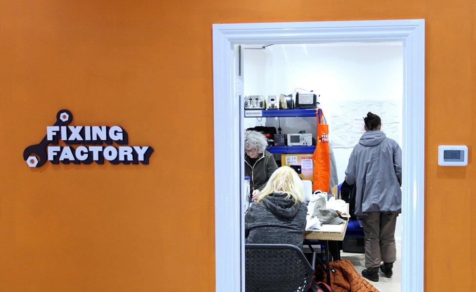 Volunteers repair electrical items at the Fixing Factory in Camden, London