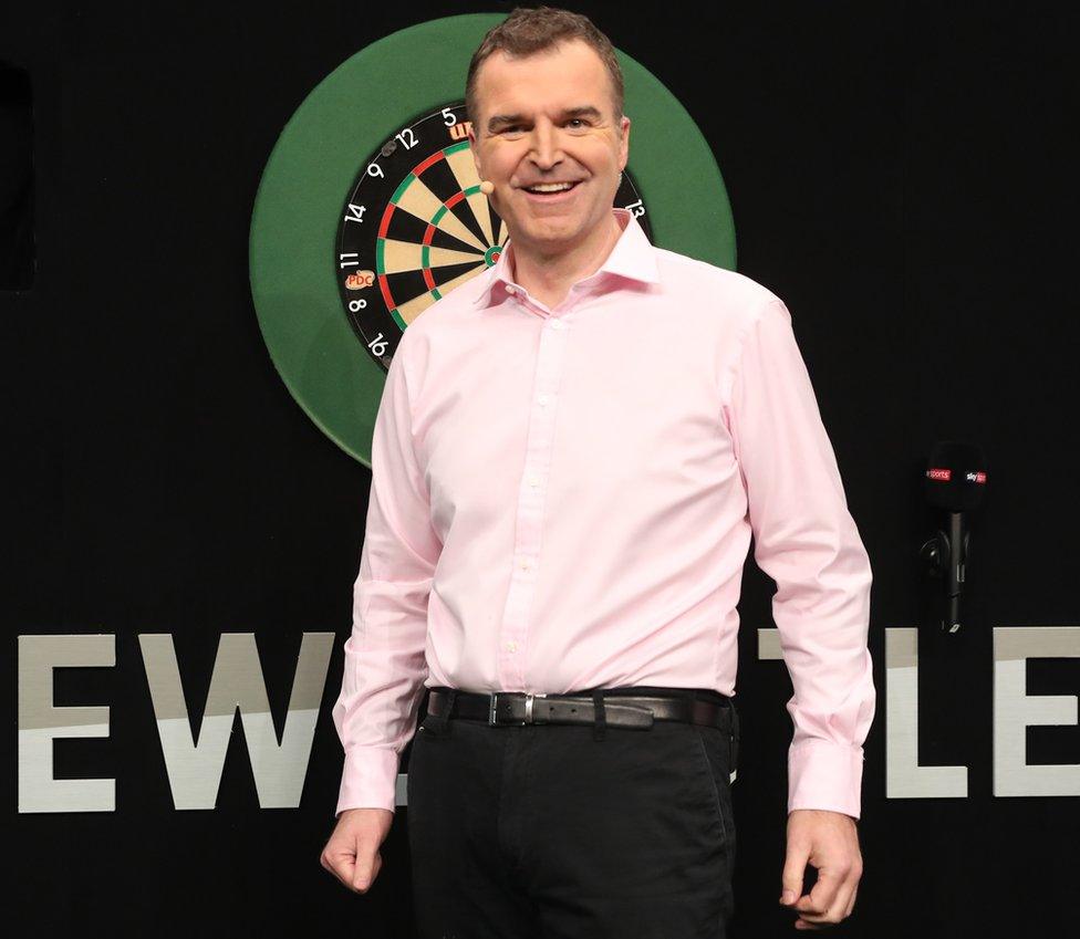 Dave Clark in front of a dart board in Newcastle