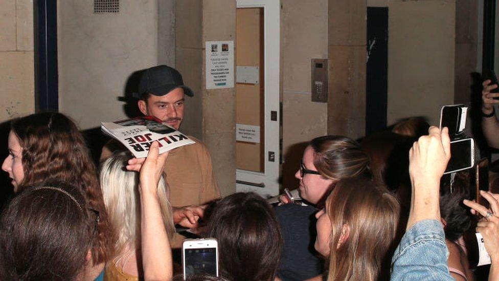 Orlando Bloom signs programmes after finishing a performance of Killer Joe