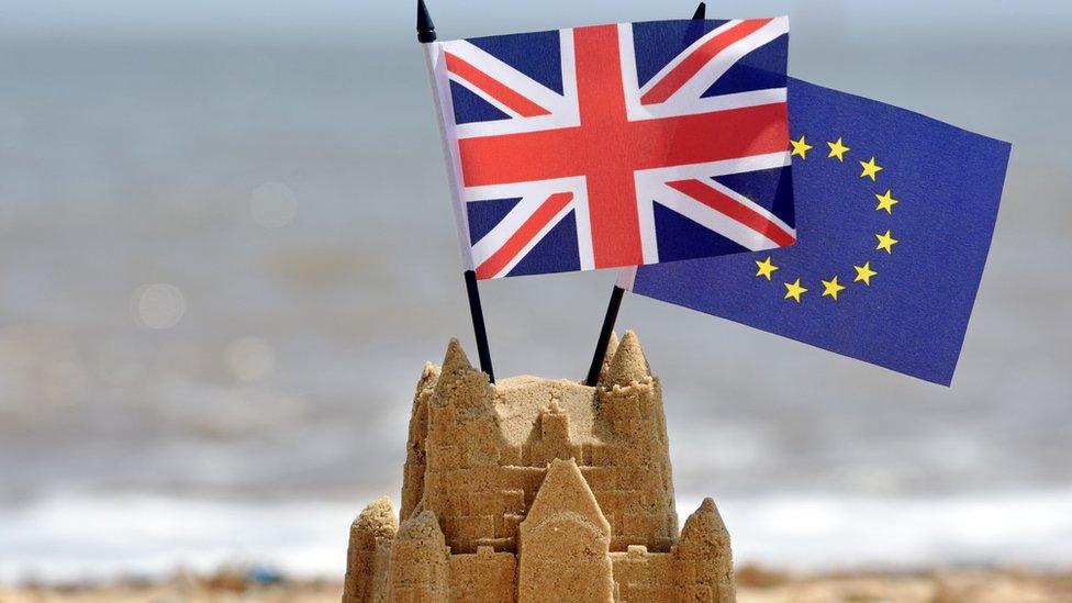 Sandcastle with union jack and EU flag