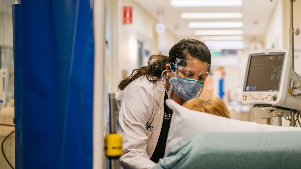 An Emergency Room nurse tends to a patient in a hallway at the Houston Methodist The Woodlands Hospital on August 18, 2021 in Houston, Texas.