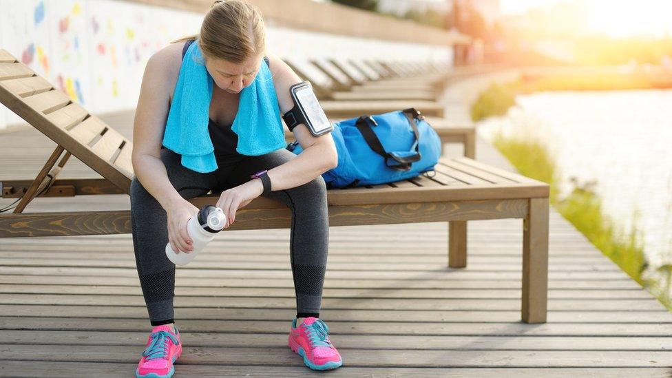 woman looking at fitness tracker on her wrist