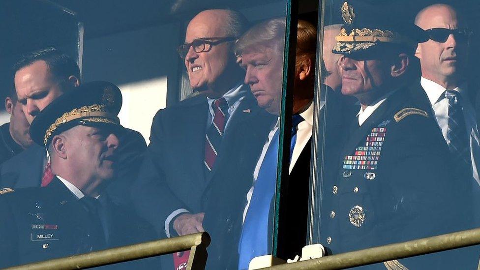 Mr Trump and Mr Giuliani attend an American football game in December 2016