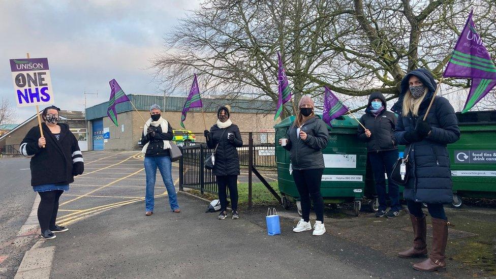 Striking union members holding banners and flags