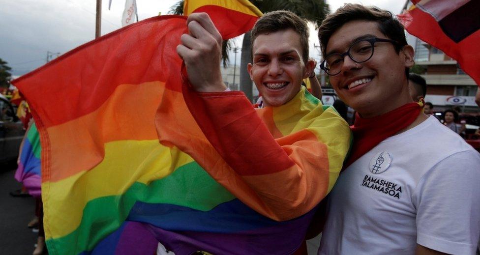 Supporters of Carlos Alvarado pose with a rainbow LGBT pride flag on 1 April, 2018.