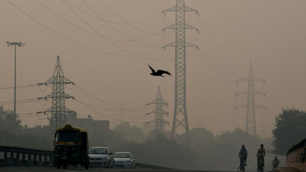 Indian commuters make their way through smog in New Delhi on October 31, 2016, the day after the Diwali festival.