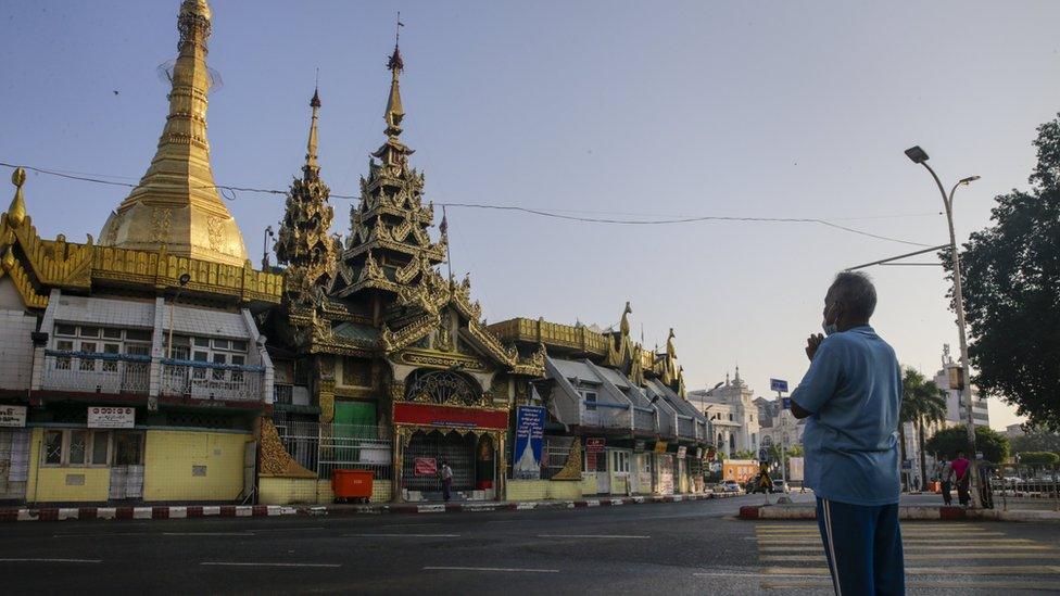 A Myanmar man prays on a platform near Sule Pagoda at downtown area in Yangon, Myanmar, 01 February 2021