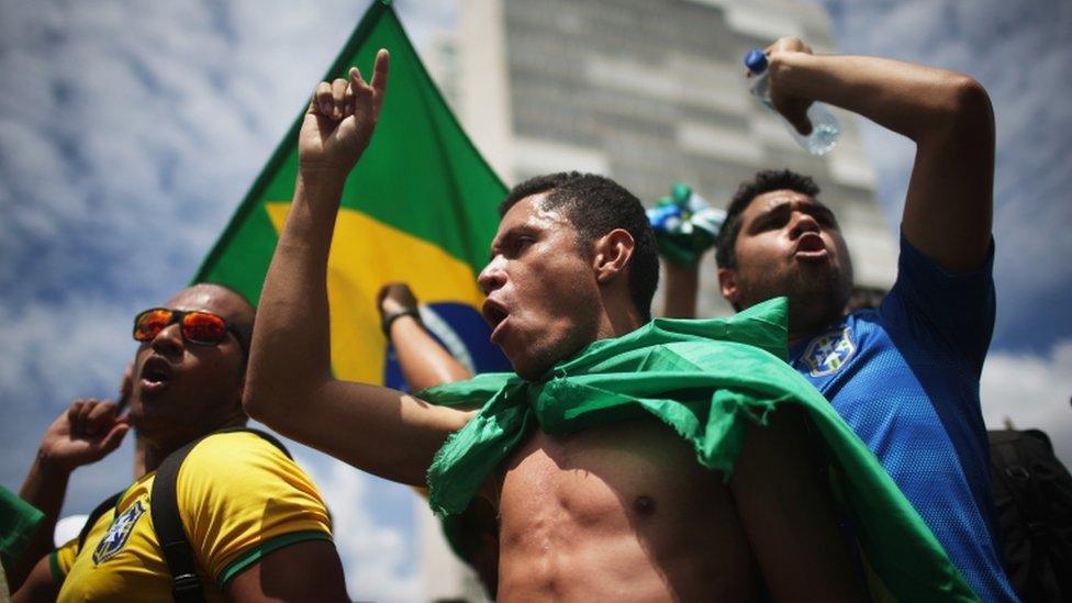 Anti-government demonstrators chant with Brazilian flags outside the National Congress building