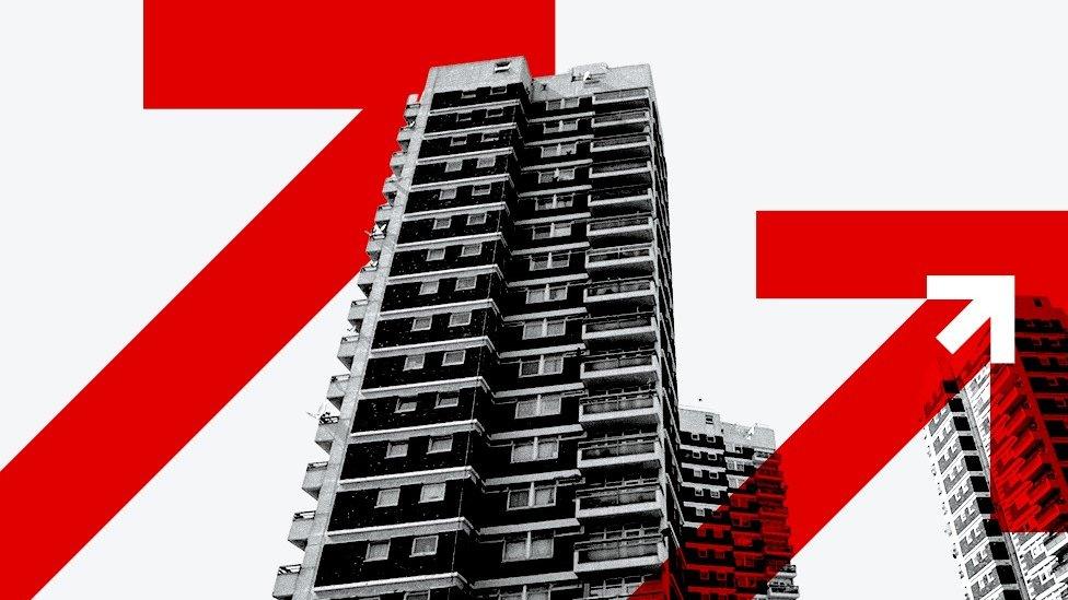 A branded black and white image of a block of flats, overlaid with red and white arrows.