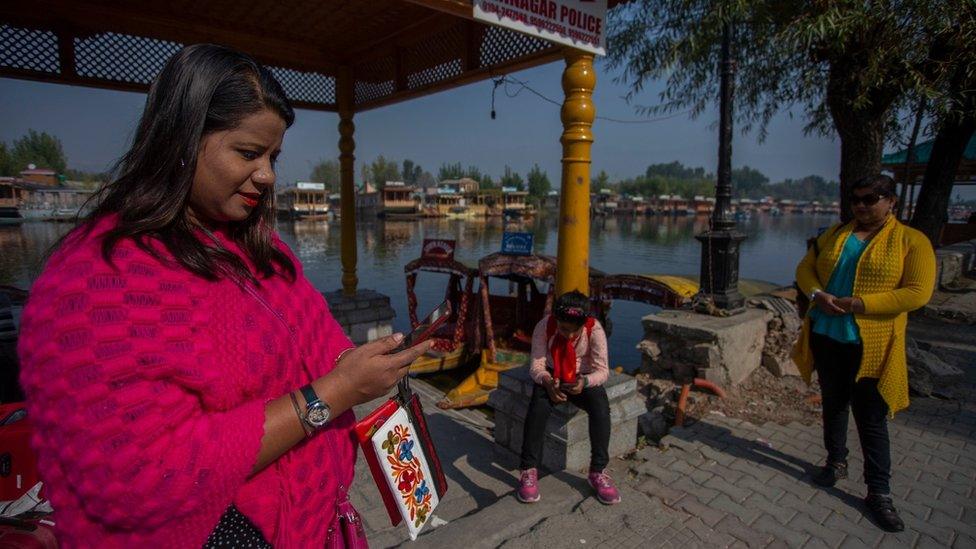 Women using mobile phones in Kashmir