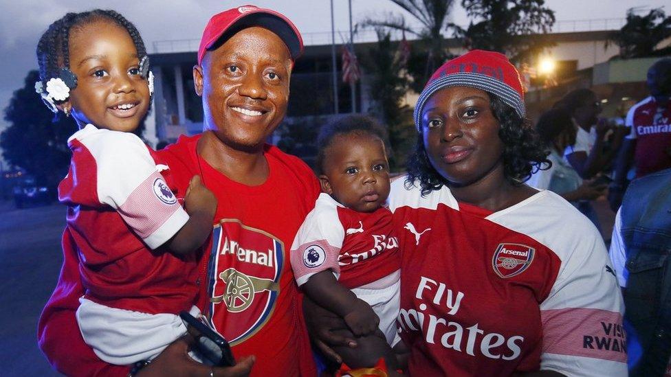 A family, fans of Arsenal, pose for a photo during the arrival of Former soccer coach Arsene Wenger at the Roberts International Airport in Harbel, Liberia, 22 August 2018.