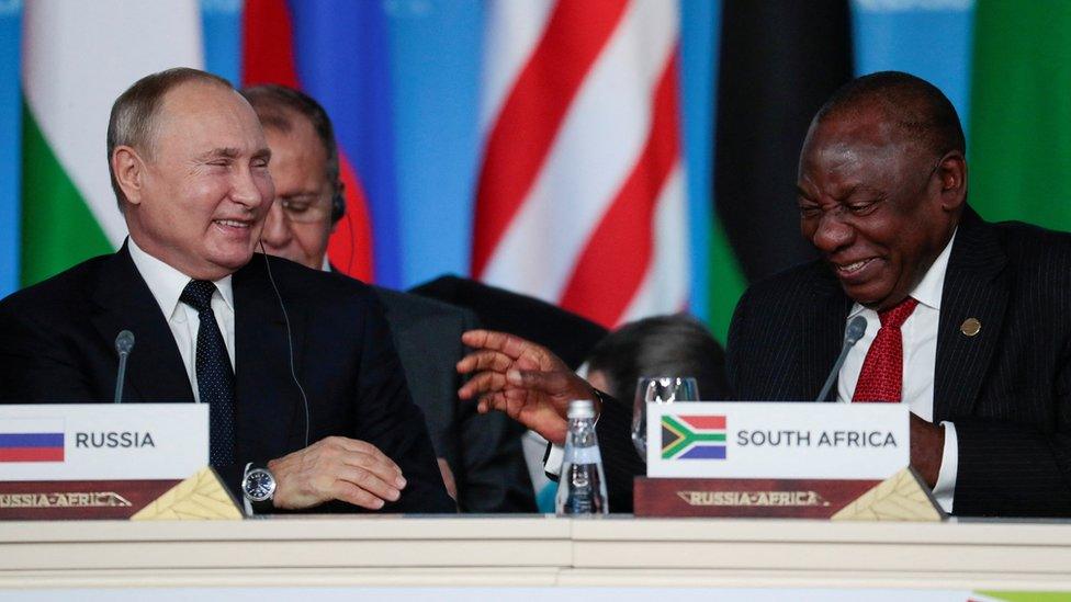 Russia's President Vladimir Putin smiles with South African President Cyril Ramaphosa at a summit in 2019