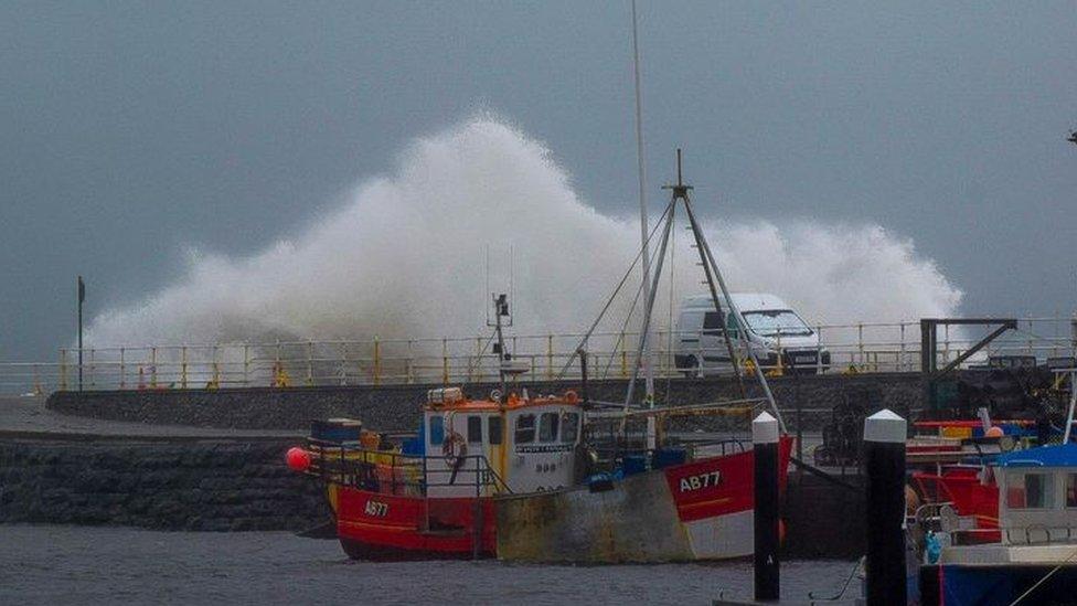 Waves breaking against the harbour wall in Aberystwyth