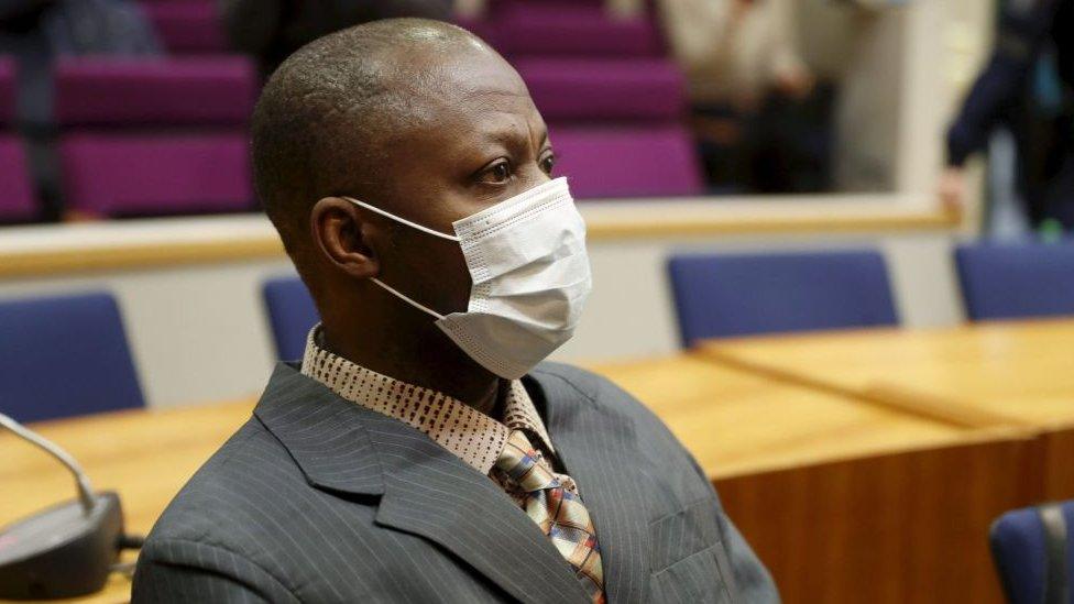 Sierra Leonean national Gibril Massaquoi, wears a face mask as he attends the first day of his trial at the Pirkanmaa District Court in Tampere, Finland