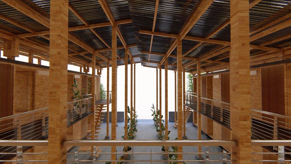 An interior view of the house shows the long stilts which stretch up from ground level to support its roof