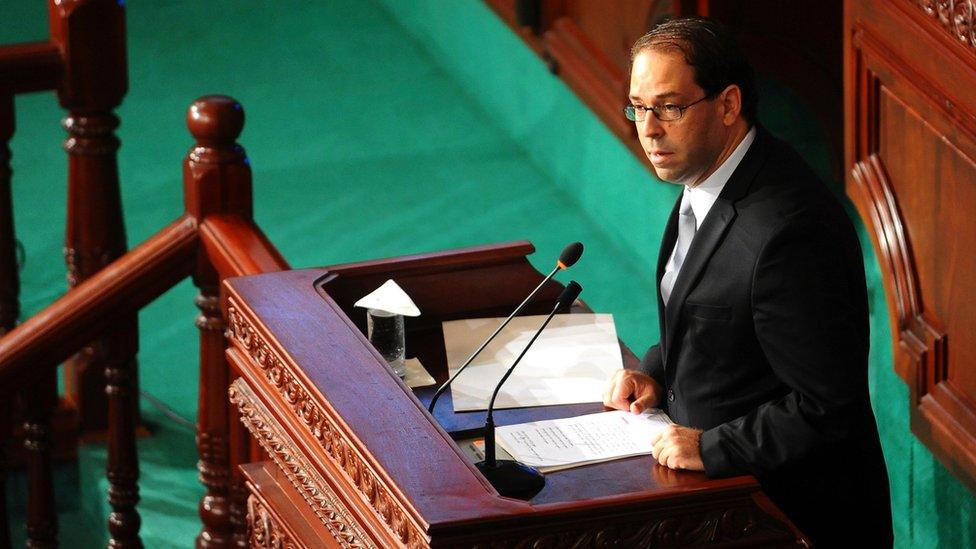 Newly named Tunisian Prime Minister Youssef Chahed, centre, delivers his speech at f the Parliament in Tunis, Friday 26 August, 2016 ahead of a confidence vote.