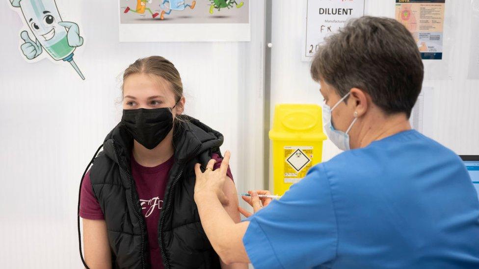 A teenage girl receiving a vaccine in Cardiff