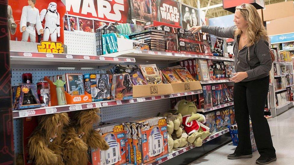 Woman looking at Star Wars toys