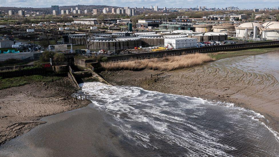 In this aerial view, discharge is seen flowing into the River Thames at Crossness sewage treatment works 