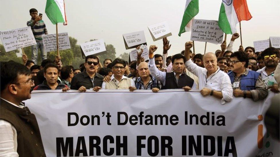 Bollywood actor Anupam Kher, third from right, and other supporters of India's ruling Bharatiya Janata Party march toward the Rashtrapati Bhawan or Presidential Palace during a protest in New Delhi, India, Saturday, Nov. 7,