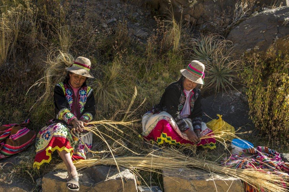 Women weave the thin ropes that are joined to make the larger ones used on the bridge