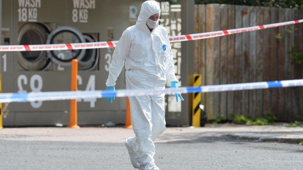 A forensic officer at the scene of the shooting