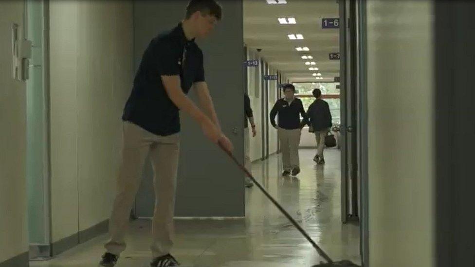 Tommy mopping the floor