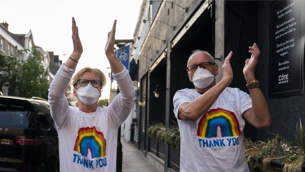 Members of the public applaud during the "Clap For Our Carers" campaign