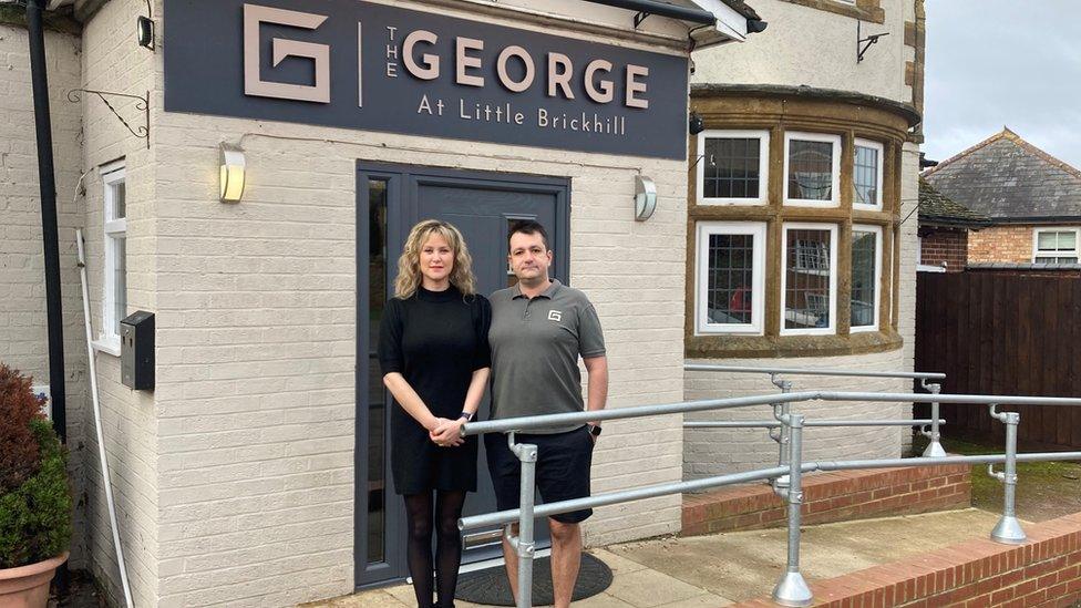 Simon and Louise Babikian standing outside The George pub