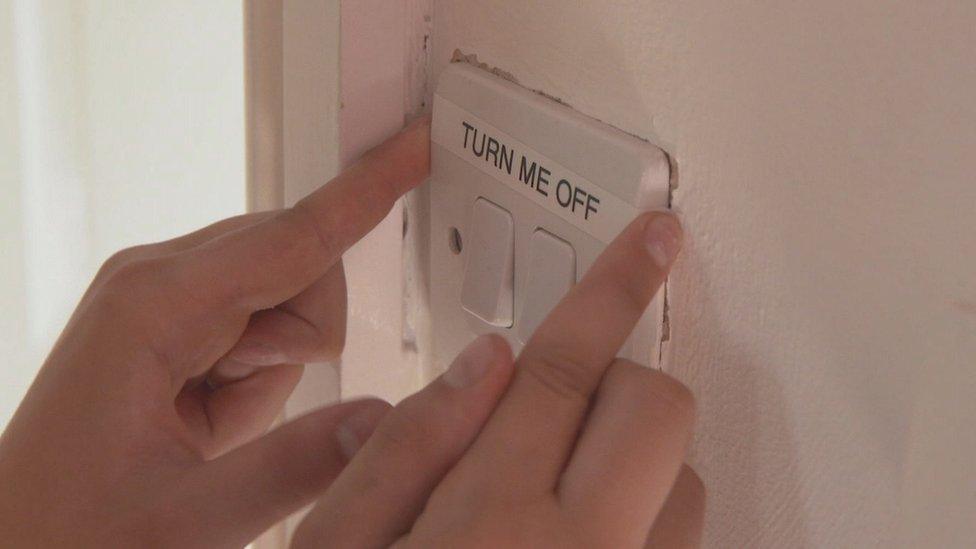 Dylan-places-a-'switch me off'-label-on-the-light-switch.