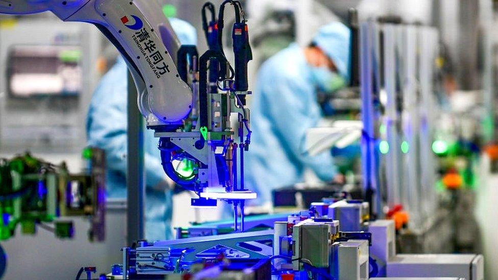 A robotic arm is seen on the assembly line of computer at a computer manufacturing enterprise set up by Tsinghua Tongfang Co., Ltd on February 22, 2022 in Jinhua, Zhejiang Province of China.