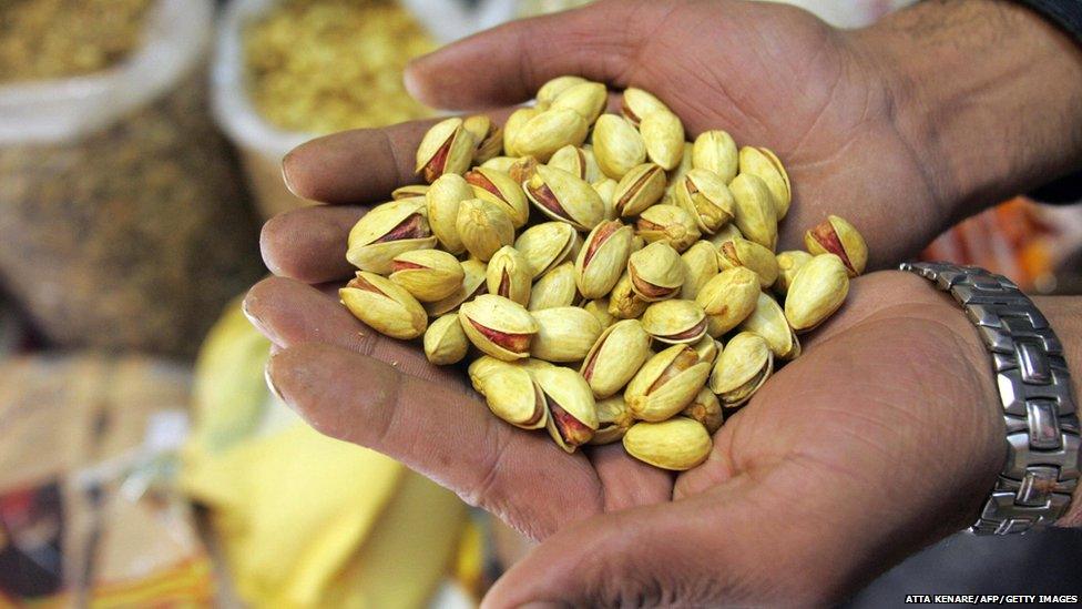 A pistachio wholesaler shows his goods at his shop in Tehran 18 November 2006.