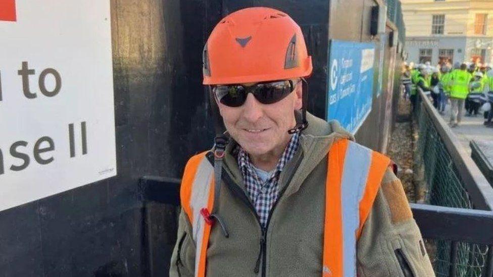 Glen Edwards, a man wearing sunglasses, an orange hard hat and an orange high-vis jacket.