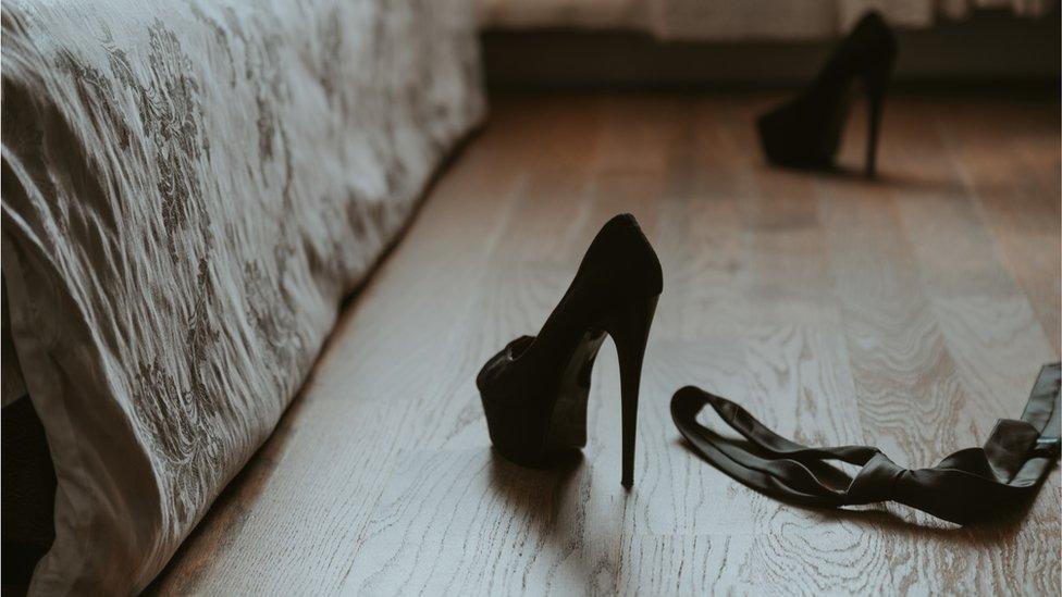 High heels and a tie on the floor