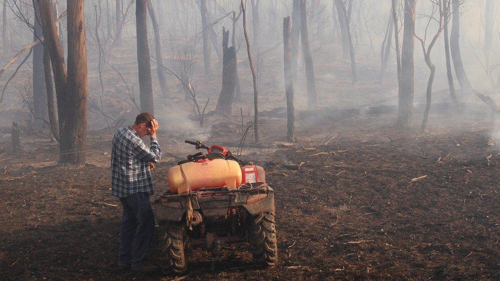 A farmer struggles with the conditions on his property near Labertouche, Victoria