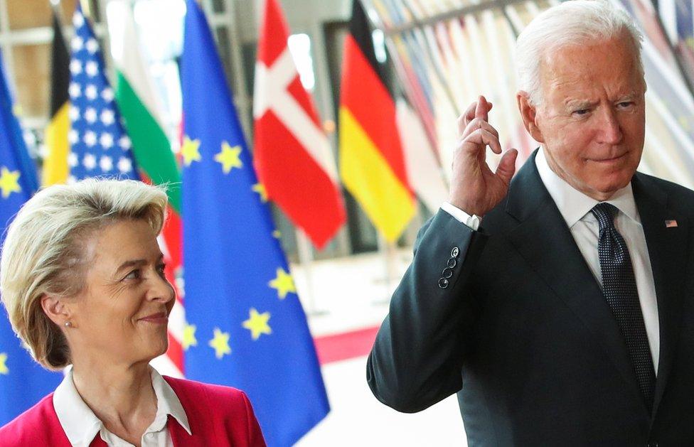 US President Joe Biden crosses his fingers next to European Commission President Ursula von der Leyen as they attend the EU-US summit, in Brussels, Belgium June 15, 2021