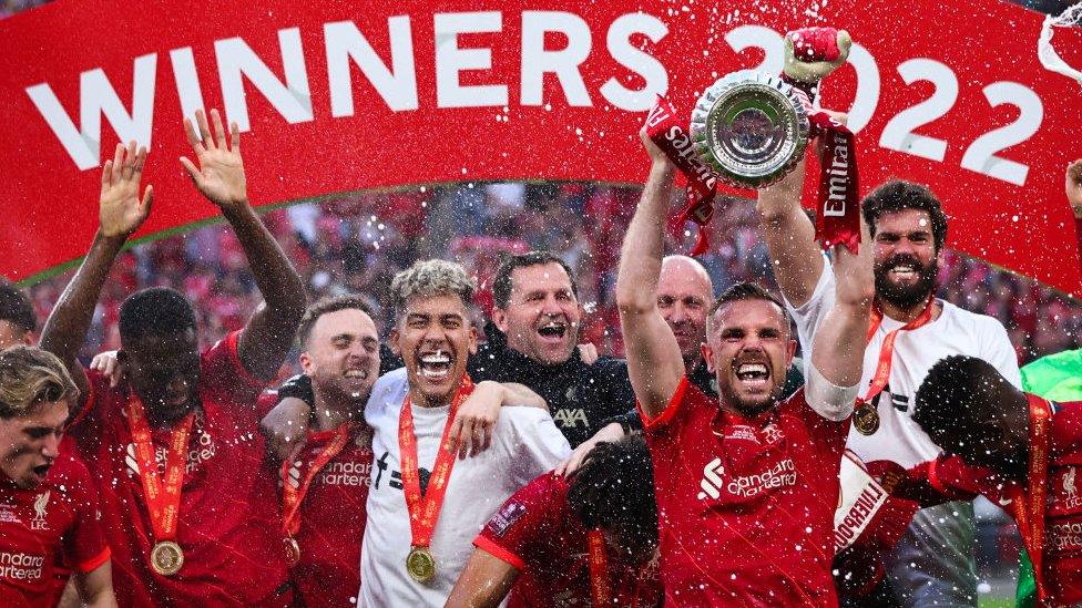 Jordan Henderson and his team mates at Liverpool celebrate with the Emirates FA Cup trophy