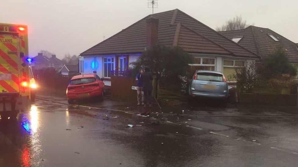 Two cars crash into house