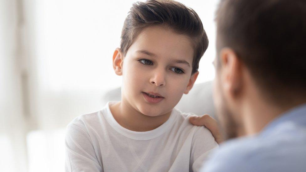 Boy talking to his dad